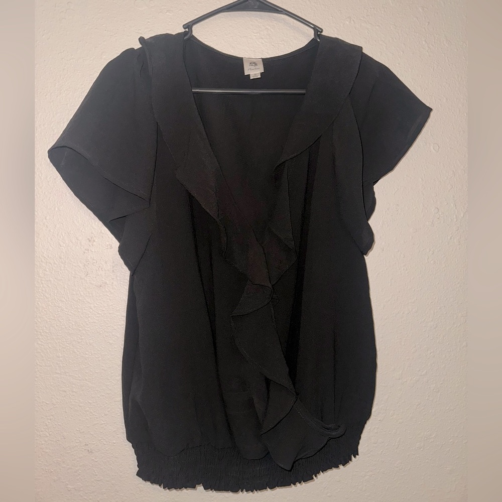 NWOT. Black top with flowy ruffle detail down the front. V neck. Size medium